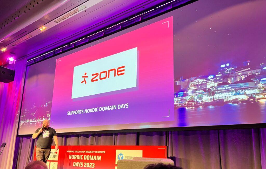 Image of Lars "LG" Forsberg opening the Nordic Domain Days event in Stockholm. Zone.eu logo is displayed on stage.